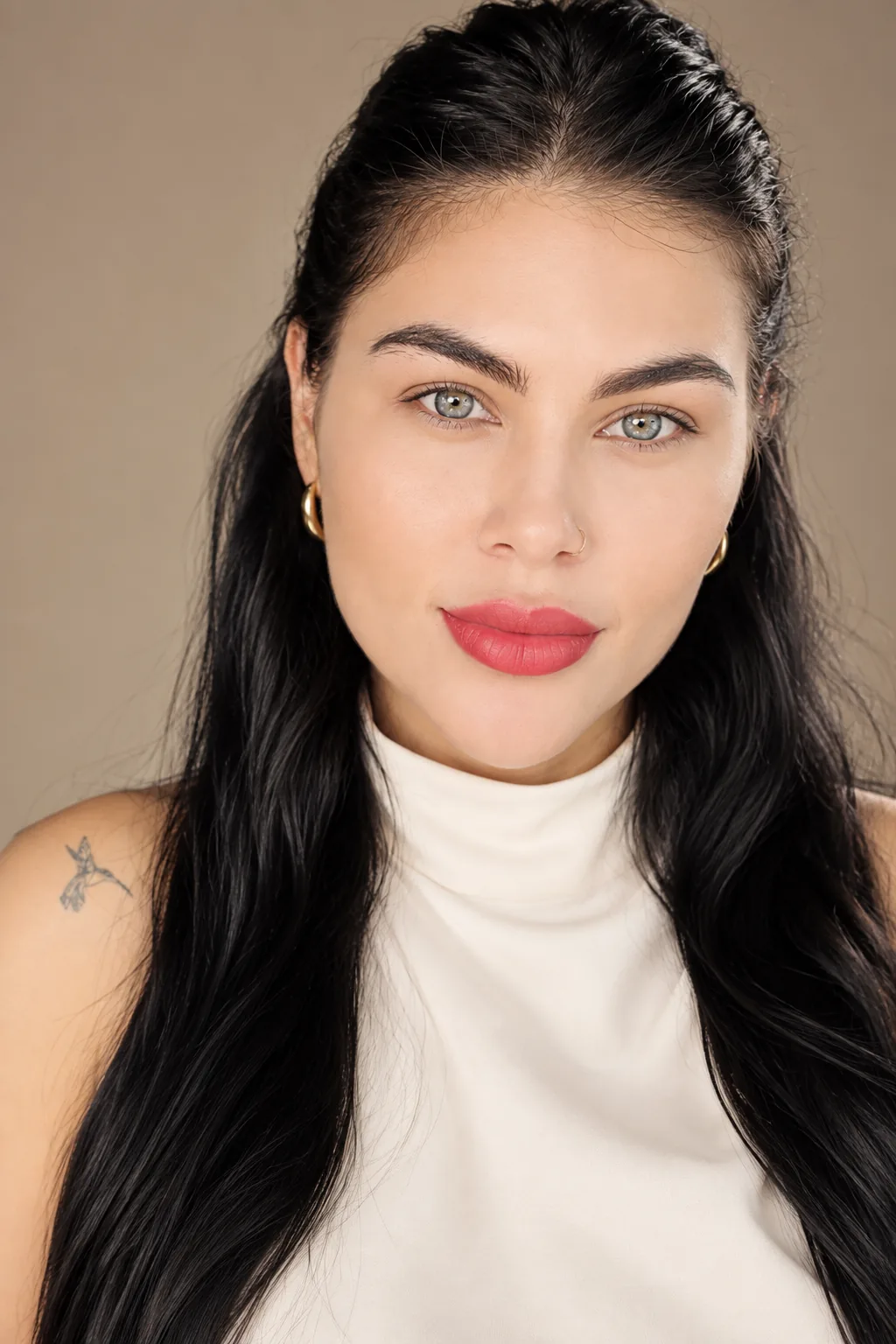 Camila Vasquez, founder of LUNÉVIA, in a white high-neck top with long dark hair.